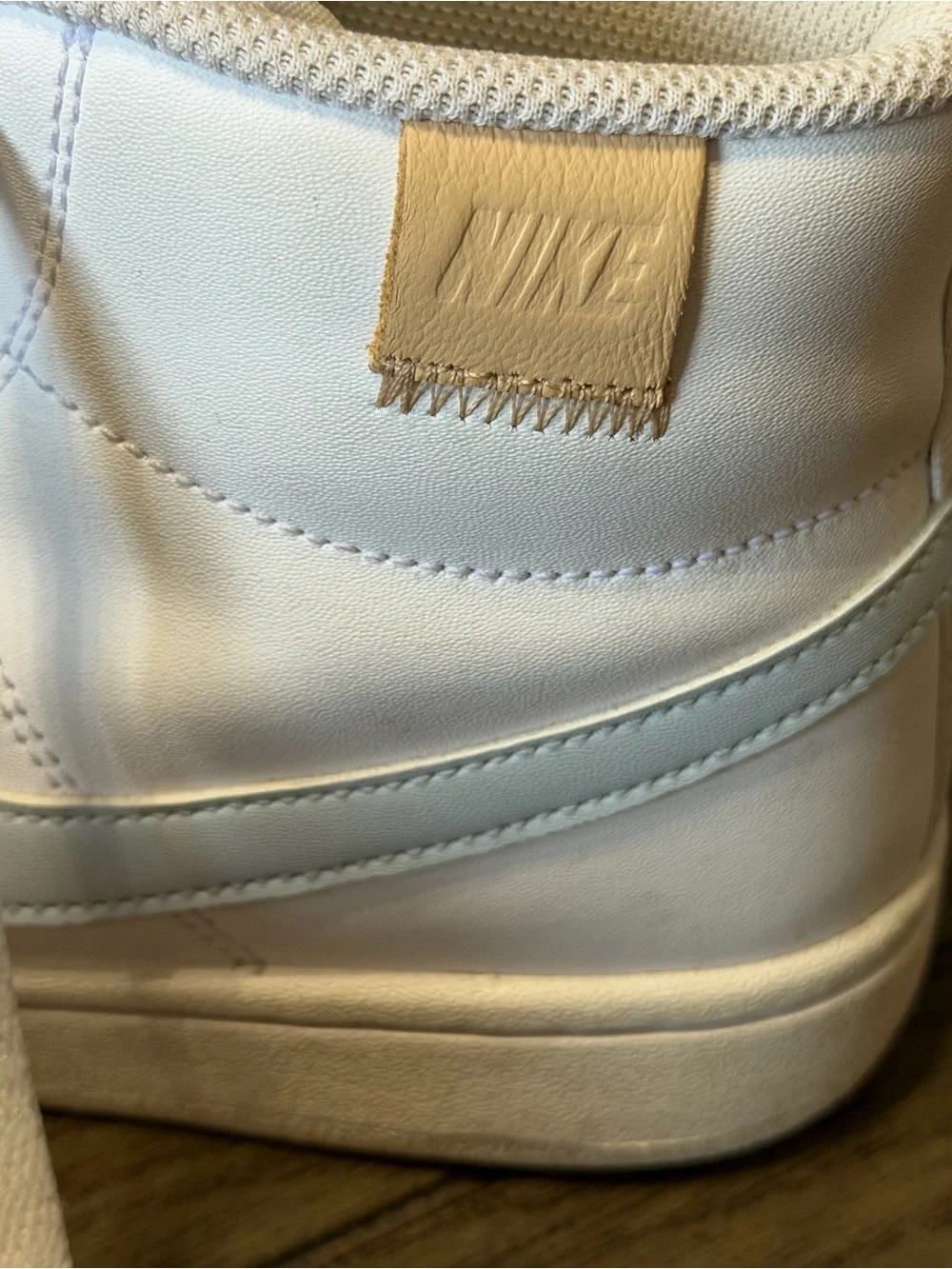 Nike White High-Top Sneakers with Light Blue Swoosh and Tan Heel Tab